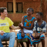 Two women from a developing country with a Light for the World staff member