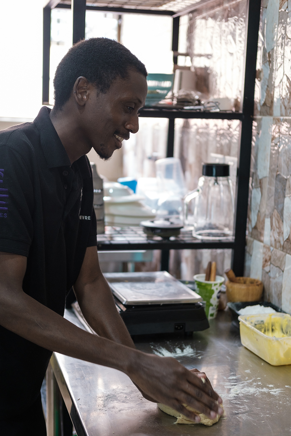 Chris kneads dough in a kitchen restaurant