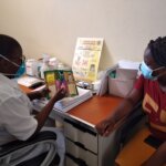 Nurse Julia explaining the medication to her patient © Light for the World