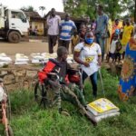 Isabella, a young Ugandan woman with disability trained as disability inclusion facilitator, coordinating the food distribution in Karamoja in Northern Uganda.