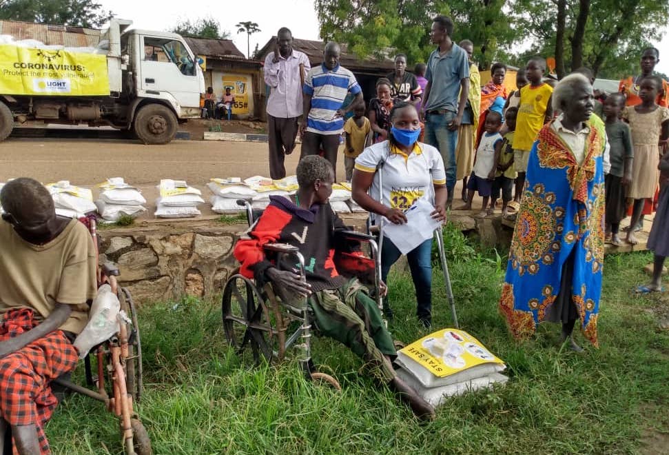 Isabella, a young Ugandan woman with disability trained as disability inclusion facilitator, coordinating the food distribution in Karamoja in Northern Uganda.