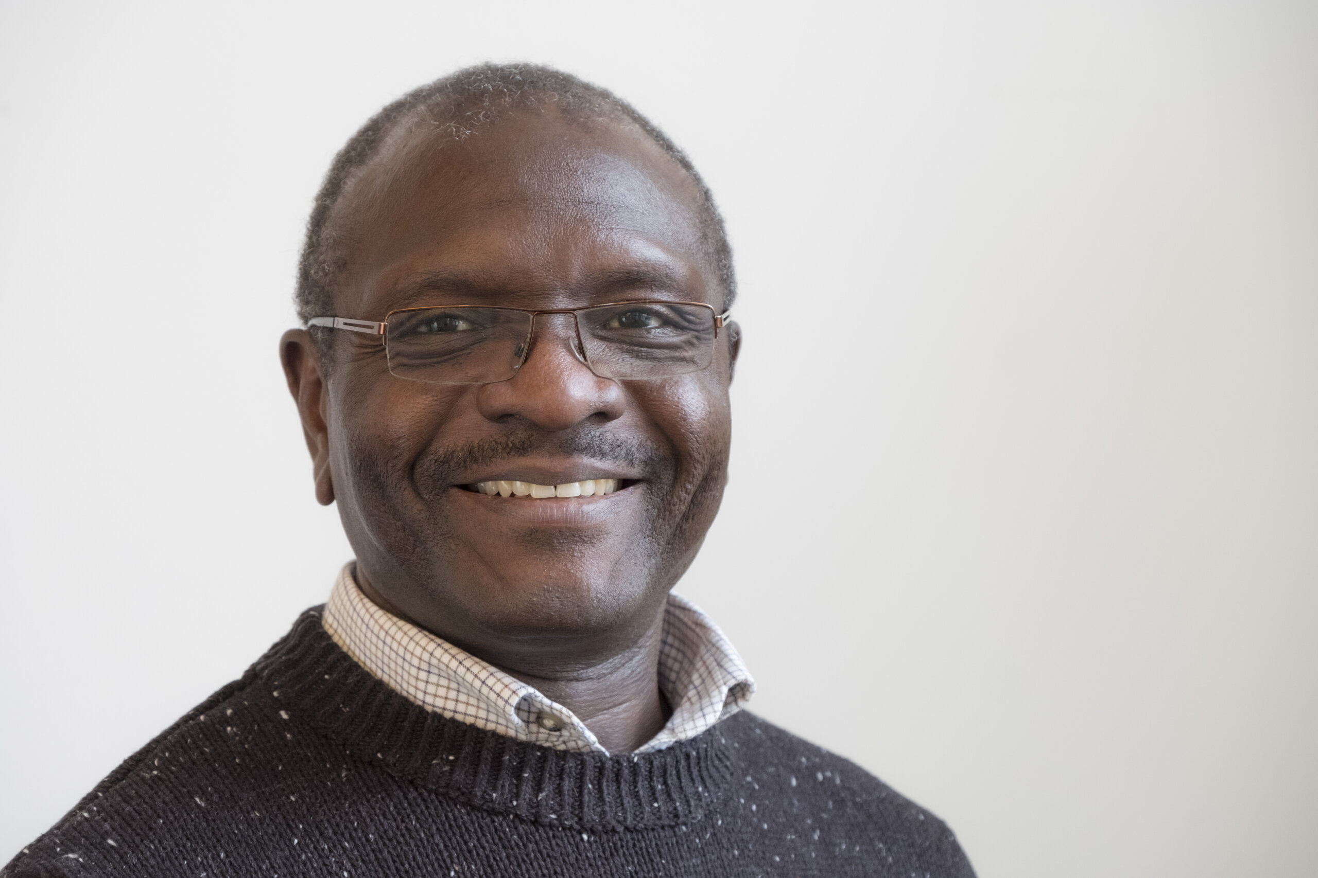 portrait of Dr Geoffrey Wabulembo a Ugandan middle-aged man with glasses