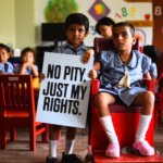 Two kids holding up a sign saying 