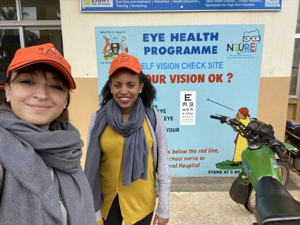 Flavia and Alem in front of the vision corridor at Entebbe Hospital in Uganda