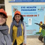 Flavia and Alem in front of the vision corridor at Entebbe Hospital in Uganda