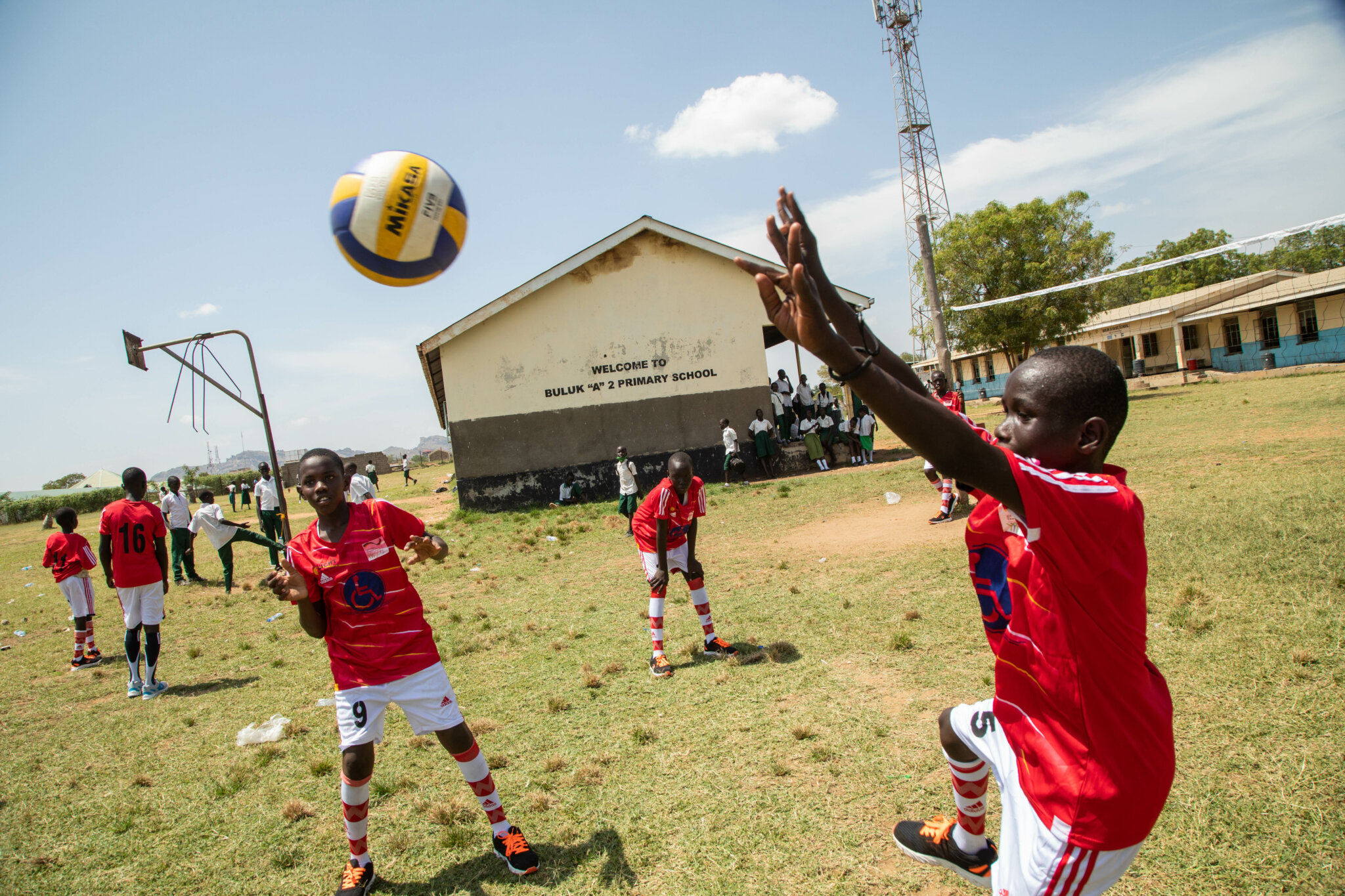 An action shot of a deaf child playing volleyball