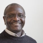 Geoffrey Wabulembo, a Ugandan black middle-aged man with glasses, smiling