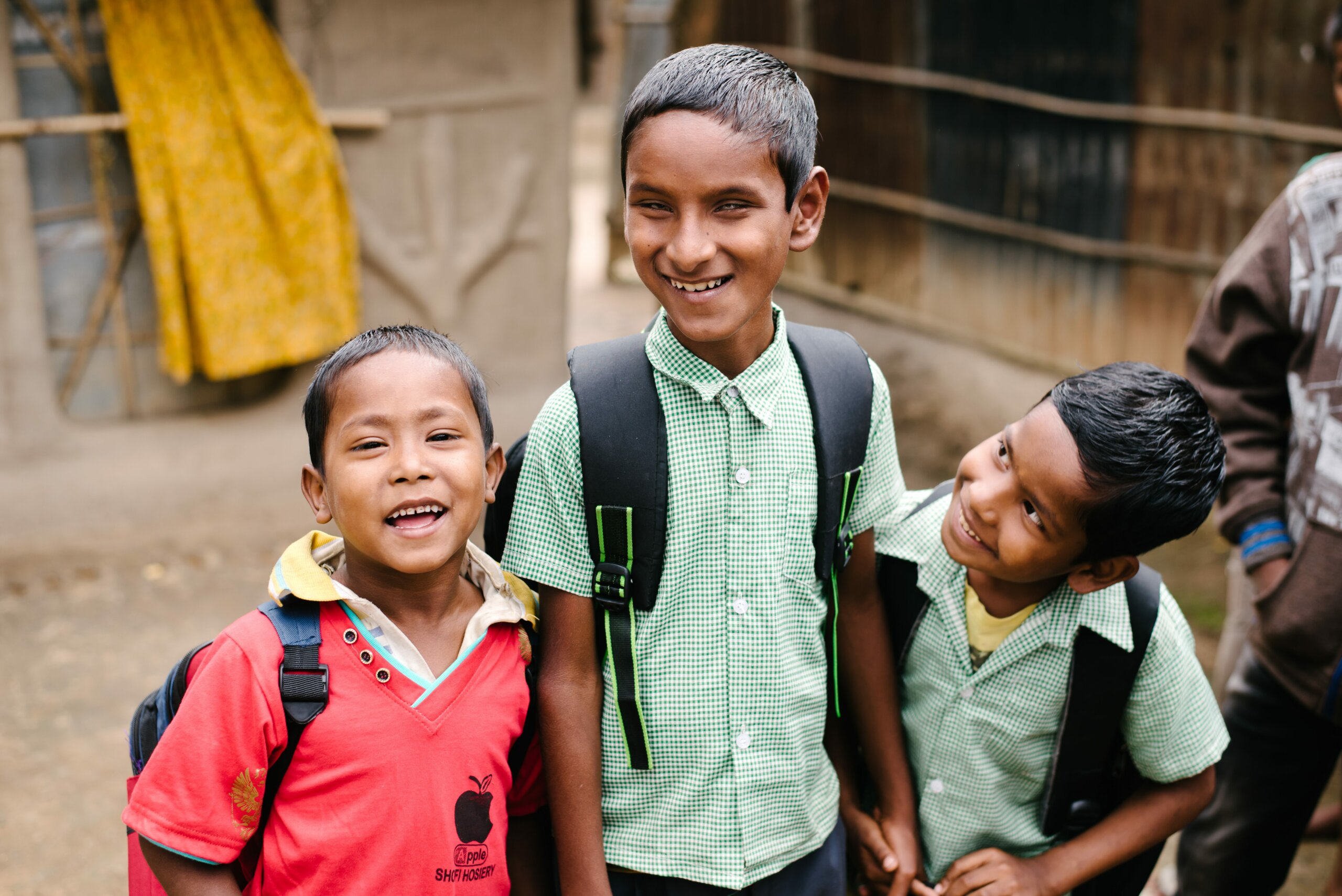 Ten year-old Naresh is blind. He stands and laughs with his two friends on their way to school