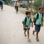 Two children in India walk to school