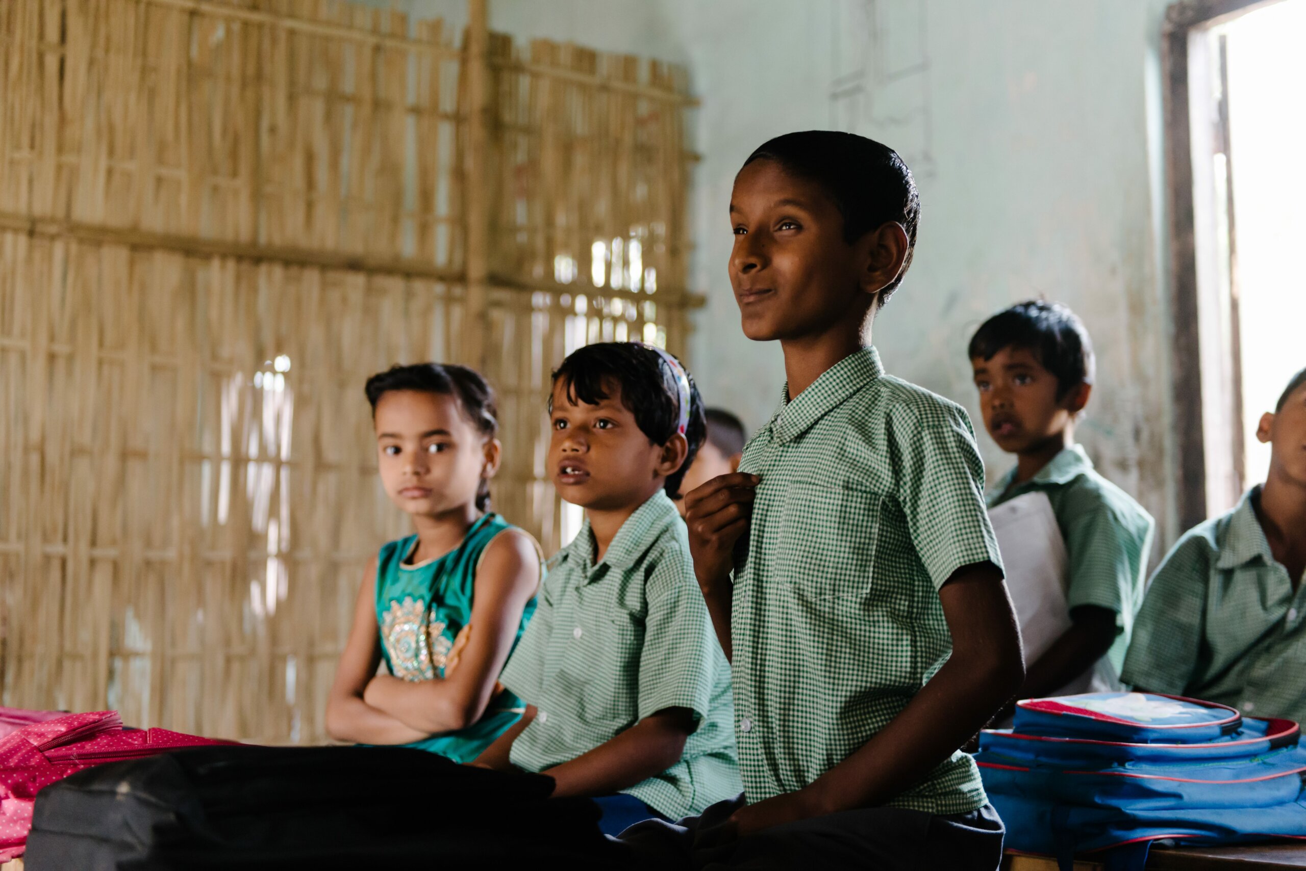 Naresh sits in a school classroom listening to the teacher