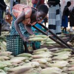 Grace displays crops for sale in Uganda