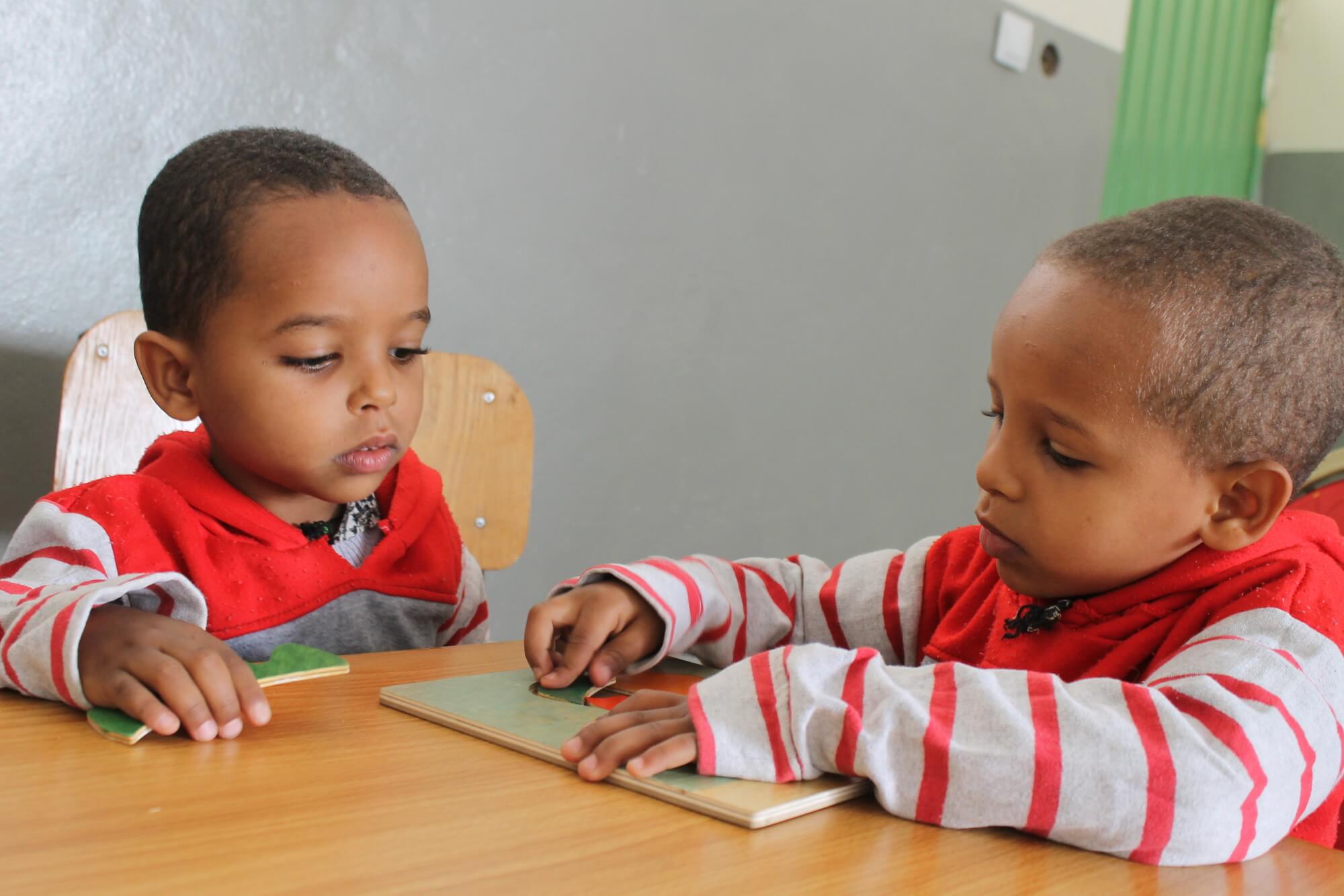 Image of young brothers Natenael and Amanueal, who are both Deaf, working at a desk. The brothers attend school with support from Rehabilitation Services for the Deaf (RSDA). RSDA is a partner of Light for the World that implements inclusive education in Addis Ababa, Ethiopia. Copyright for the image is Light for the World 