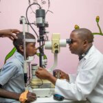 Dr. Vasco da Gama examines the eye of a young boy in Quelimane, Mozambique. Dr Vasco da Gama is a pioneer in the drive to improve child eye health in Mozambique.
