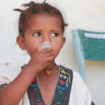 A young Ethiopian girl takes medication as part of the first child MDA against trachoma in Tigray.