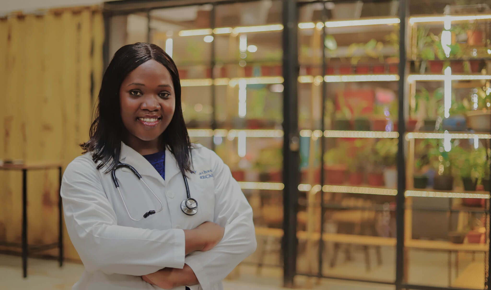 Overall Winner: Dr. Racheal Kalinaki – Uganda. She is dressed in a doctor's jacket and is smiling at the camera.