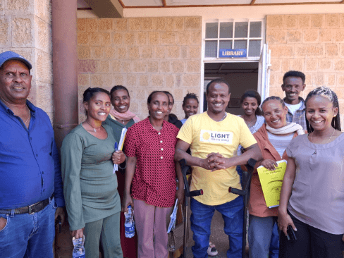A group of ophthalmic nurses and a Disability Inclusion Advisor from Light for the World. All are smiling and looking at the camera.